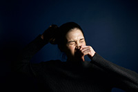 Woman holding nose and sneezing depicting allergy symptoms that can be relieved with professional Monmouth County air conditioner repair