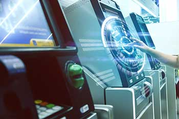ITM service graphic; hand reaching out to use an ITM in a bank of machines with a technology icon superimposed
